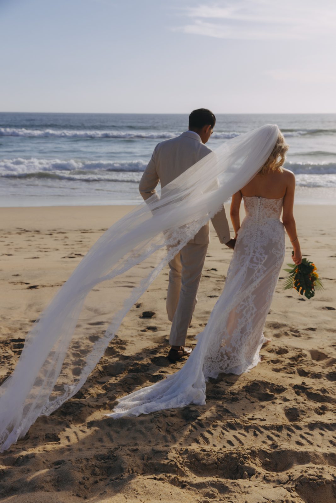 Kelly and Sameer walking along the shore at Los Cerritos