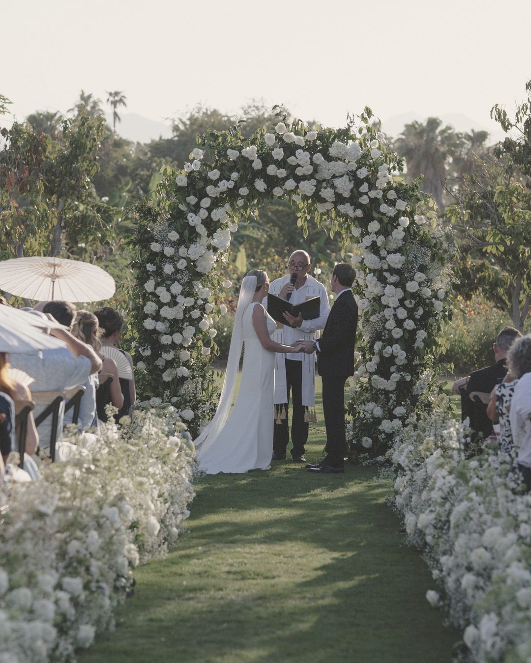 Garden ceremony under a floral arch