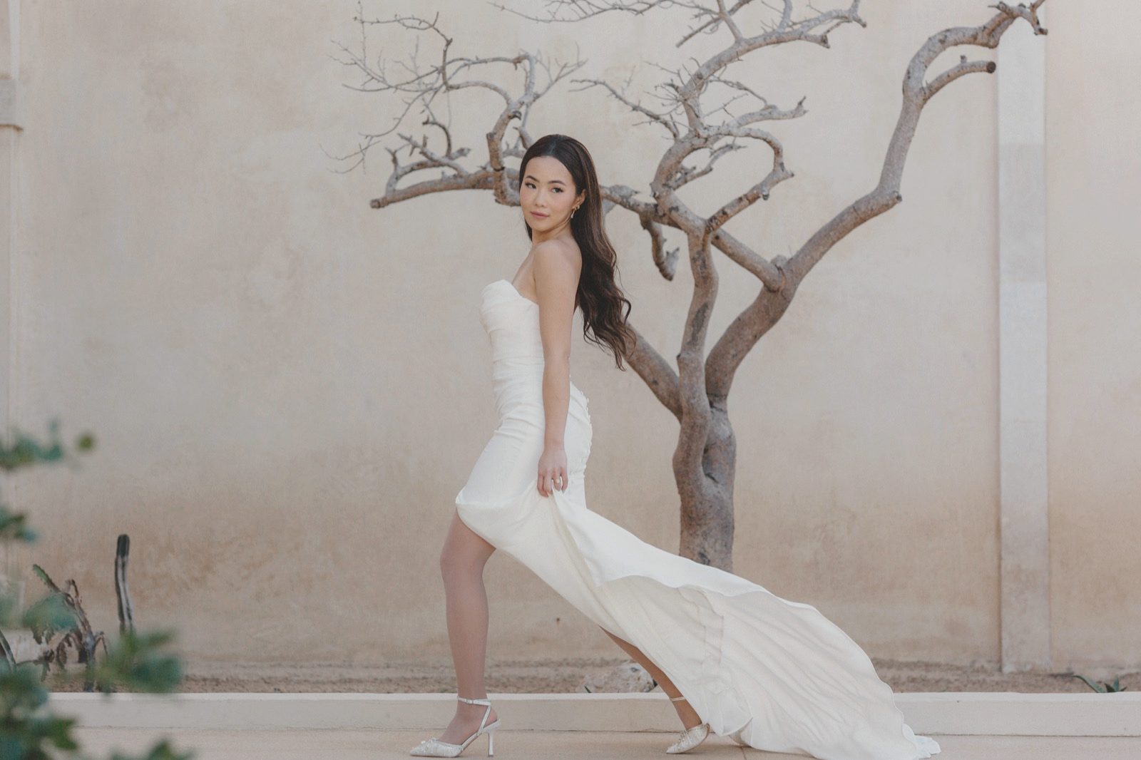 Editorial bridal portrait against a sculptural wall